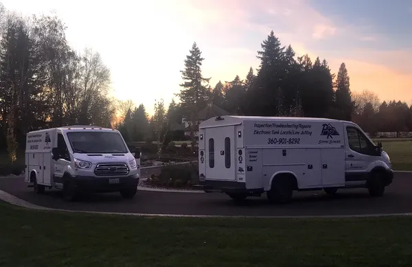 PR Septic Service trucks at sunset